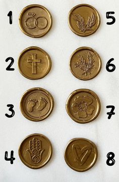 six different types of wax seals with numbers and symbols on them, all in gold