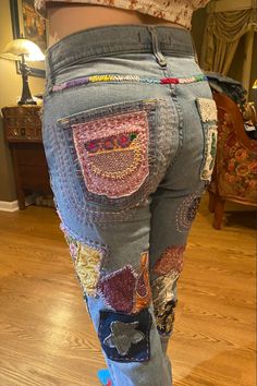 the back of a woman's jeans with patches on them