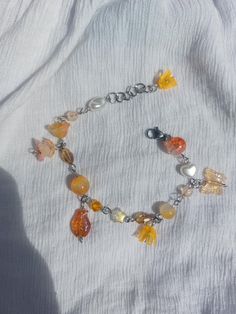 𐙚 Whimsical orange themed bracelet inspired by the autumn season and a Ghibli character Calcifer. It's made with a combo of round orange beads, butterfly & fish charms and flower beads.  𐙚 The bracelet is 7.6 inches(19.5cm) and adjustable till 8.7inches(22.2cm) 𐙚 Be mindful of your jewelry when engaging in physical activities or sports. Remove your jewelry to prevent accidental damage. 𐙚 Lovely gift to treat yourself to or gift your family and friends who loves Ghibli or who's an autumn love Ghibli Calcifer, Ghibli Character, Beads Butterfly, Keep Bracelet, Butterfly Fish, Cluster Bracelet, Cluster Bracelets, Bracelet Beaded, Bead Charm Bracelet