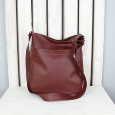 "If you value sophisticated accessories and you're looking for a multifunctional bag in gorgeous color, you are in a good place. This simple burgundy hobo purse looks great as shoulder or crossbody tote. Fits really well with any womens casual outfit. Made of high quality vegan leather. One of the bags perfect for everyday use - for work, shopping or little talks with your best friend. Easy to pack, large enough for all your items on the go. Cotton lining with three pockets, one of them fastened Versatile Crossbody Bucket Bag With Zipper Pocket, Zipper Pocket Shoulder Bucket Bag, Versatile Faux Leather Hobo Bag Crossbody, Versatile Faux Leather Crossbody Hobo Bag, Everyday Crossbody Shoulder Bag With Zipper, Everyday Crossbody Shoulder Bag With Zipper Closure, Versatile Faux Leather Tote Shoulder Bag, Large Capacity Crossbody Hobo Bag, Everyday Faux Leather Hobo Shoulder Bag