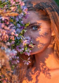 a beautiful young woman with blue eyes and flowers in her hair