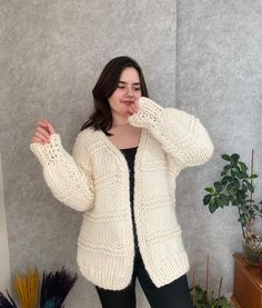 Chunky wool cardigan, oversized cream  jacket, hand knitted cream sweater. This cardigan is knitted by 100% wool. It's great oversized jacket for cold winter days, very soft and warm. If you have any other size preference, please let me know. Happy to accommodate your request. For any other questions, please email me :) The model is 170cm tall.  Length 72cm Width 80cm Sleeve 47cm Hand knit items should be hand washed in warm water with mild detergent and laid flat to dry. Less Cream Wool Knitted Sweater Coat, Cream Knitted Wool Sweater Coat, Cozy Chunky Knit Sweater Coat In Winter White, Cream Oversized Knitted Outerwear, Oversized Cream Knitted Outerwear, Beige Hand Knitted Fall Knitting Pattern, Oversized Beige Wool Cardigan, Hand Knitted Beige Knitting Pattern For Fall, Oversized Hand Knitted Beige Sweater