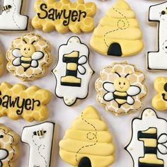 decorated cookies are arranged in the shape of numbers and honeybees with bees on them