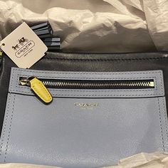 Coach Legacy Colorblock Leather Wristlet In Navy/Chambray With Silver-Tone Hardware (48875, Svb3z) 8" L X 5" H X 1.75” W. Features Colorblock Leather; Contrasting Zipper Pull/Hangtag; Exterior Zip Pocket; 3 Interior Credit Card Pockets & One Large Slip Pocket; Zip-Top Closure; Detachable Wrist Strap; Embossed Coach Logo On Front; Mini Tassels; And 2 Hangtags. Includes Box, Care Card And Tags. Coach Blue Clutch For Everyday Use, Blue Coach Clutch For Everyday Use, Blue Leather Coach Wallet, Coach Blue Wallet With Removable Pouch, Coach Clutch, Coach Legacy, Laser Cut Leather, Coach Logo, Patchwork Fabric