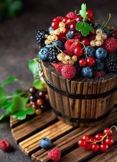 berries and raspberries in a wooden basket