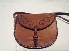 Vintage 1980's handmade brown leather handbag - shoulder bag. Measurements: H - 10'' [ 25cm.] W - 10'' [ 25cm.] Side - 2'' [ 5cm.] One section inside. Leather long handle - 28'' [ 70cm.] Small front spot - photo 4. Used.Very good vintage condition. NOTE: All vintage items in my shop that are used have been restored according to the possibilities All defects are removed,except the normal signs of use over the years. Thank you and successful shopping. Retro Brown Saddle Shoulder Bag, Retro Brown Saddle Bag Satchel, Retro Brown Satchel Saddle Bag, Retro Brown Saddle Satchel Bag, Vintage Brown Saddle Satchel, Vintage Brown Saddle Shoulder Bag, Handmade Retro Brown Bag, Handmade Retro Brown Bags, Handmade Brown Saddle Bag