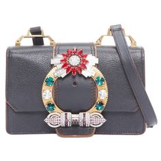 MIU MIU Lady black leather colorful rhinestone buckle flap crossbody bag Reference: CELE/A00039 Brand: Miu Miu Designer: Miuccia Prada Model: Miu Lady Material: Leather Color: Black, Multicolour Pattern: Solid Closure: Magnet Lining: Black Microsuede Extra Details: Grained leather small bag detailed with a multicolour rhinestone maxi buckle on flap, snap fastening, smooth leather shoulder strap, one inner zipped pocket, an open one and suede interior. CONDITION: Condition: Good, this item was pr Miu Miu Bag, Crossbody Bag Women, Dress Code, Small Bag, Fashion Handbags, Fashion Photo, Shoulder Handbags, Miu Miu, Purses Crossbody