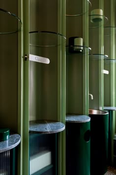 a room filled with green shelves next to each other