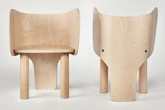 two wooden chairs sitting next to each other