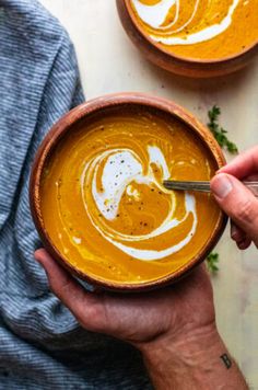 two bowls filled with soup on top of a table