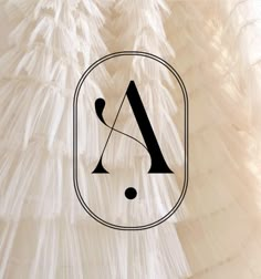 the logo for a wedding dress with ruffles on it and an arrow in the middle