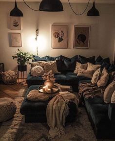 a living room filled with lots of furniture next to a wall mounted light and pictures on the wall