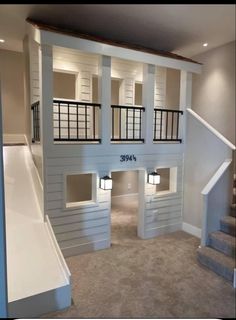 an empty room with stairs leading up to the second floor and two lofts on each side