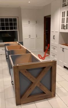 an unfinished kitchen with white cabinets and tile flooring