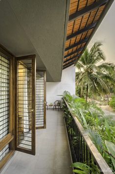 an open balcony with wooden shutters and white walls