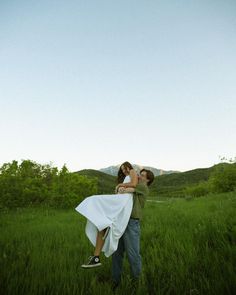 a man carrying a woman on his back in a field