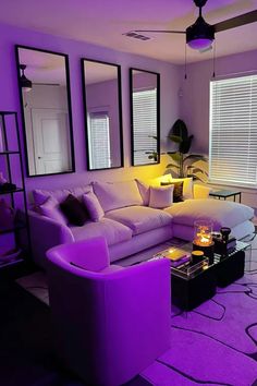 a living room filled with furniture and purple lighting