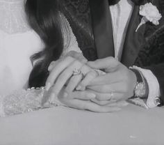 black and white photograph of a bride and groom with their hands on each other's fingers