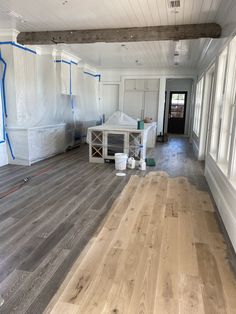 an empty room with white walls and wood floors in the process of remodeling