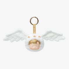 a keychain with an angel doll hanging from it's front and side