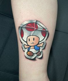 a person with a cartoon character tattoo on their leg