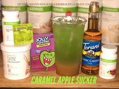 the contents of a drink sitting on top of a wooden table next to other bottles