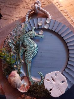 a seahorse is sitting on top of a table with seashells and shells