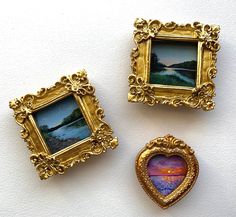 three pictures are placed next to each other in gold frames on a white surface,