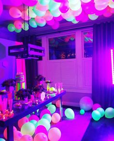 a party with balloons and lights in the room