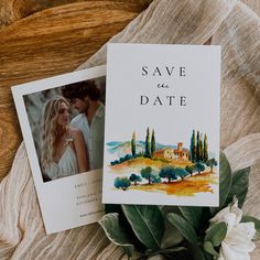 an image of a wedding save the date card on top of a table with flowers