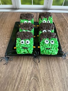 some kind of green and brown cake on a black plate