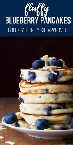 stack of blueberry pancakes on a plate with text overlay that reads, easy blueberry pancakes greek yogurt kid approved