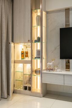 an entertainment center with shelves and lights in a room that has white tiles on the floor