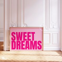 a pink poster with the words sweet dreams on it in front of a white wall