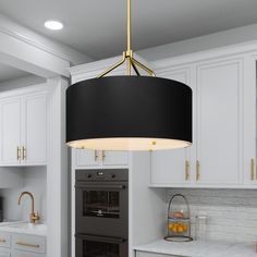 a kitchen with white cabinets and a black lamp hanging from the ceiling over the stove