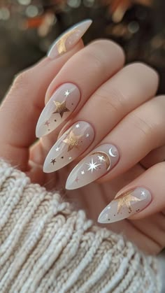 Embrace the celestial beauty of Lunar Star Nails! This trending look combines soft, nude tones with delicate gold stars, crescent moons, and tiny shimmer accents, creating a dreamy, stargazing effect. Perfect for those who love minimalist glam, this design adds a sophisticated sparkle to any outfit  #NailArt #HolidayNails #WinterNails #AcrylicNails #GelNails #NailDesigns New Orleans Themed Nails, Stevie Nicks Nails, Mexican Wedding Nails, Ethereal Nails Almond, Gold Bridesmaid Nails, Maternity Nail Ideas, Throne Of Glass Nails, 30th Nails, Boho Nails Designs Bohemian