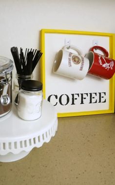 there are coffee mugs on the shelf next to each other and a sign that says coffee