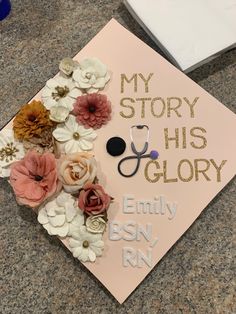 a pink graduation cap decorated with flowers and a stethoscope