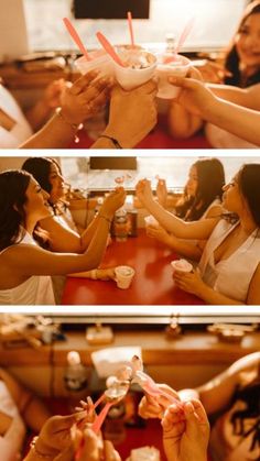 two women sitting at a red table eating food and drinking from cups with straws in their hands