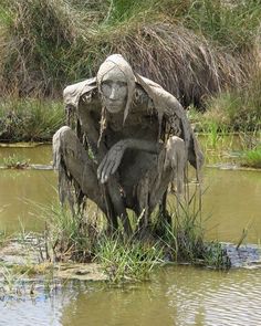 a statue sitting on top of a body of water