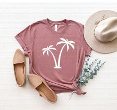 "Palm Tree Shirt, Palms Shirt, Summer Vacation T-Shirt, Palm Beach Shirt, Summer Tee, Botanical Shirt, Hawaii Shirt, Tropical Shirt ☀️☀️☀️☀️☀️ Everything in our shop is hand crafted and made to order. If you want different color or size contact me! If you would like something custom made to fit your personal style please message me and I will do everything to get you that something special. ---How To Order--- ⭐️Please, check and review all photos ⭐️Choose your t-shirt size and color ⭐️Enter your Pink Cotton Top With Palm Tree Print, Casual Cotton Tops With Palm Tree Print, Casual Cotton Top With Palm Tree Print, Summer Cotton T-shirt With Palm Tree Print, Trendy Cotton Tops With Palm Tree Print, Casual Crew Neck Top With Palm Tree Print, Cotton Crew Neck Top With Palm Tree Print, Relaxed Cotton Top With Palm Tree Print, Casual White Printed Shirt