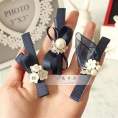 two pieces of blue ribbon with flowers and pearls