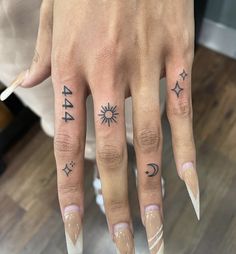 a woman's hand with tattoos on her fingers and the number 544 written in black ink