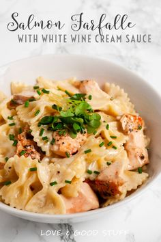 a white bowl filled with pasta and shrimp on top of a marble countertop text reads salmon parfait with white wine cream sauce