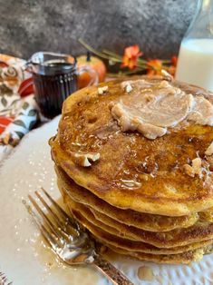 a stack of pancakes sitting on top of a white plate