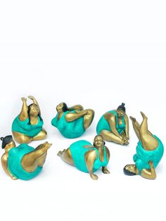 several figurines are sitting on the ground with one laying down and another standing up