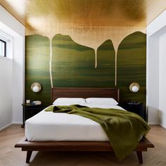 a large bed sitting under a painting on the wall