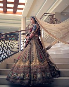 a woman in a wedding dress standing on some stairs