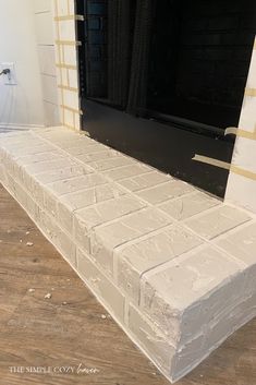 a white mattress sitting on top of a hard wood floor next to a black door