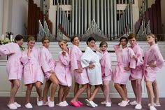 a group of women in pink robes standing next to each other